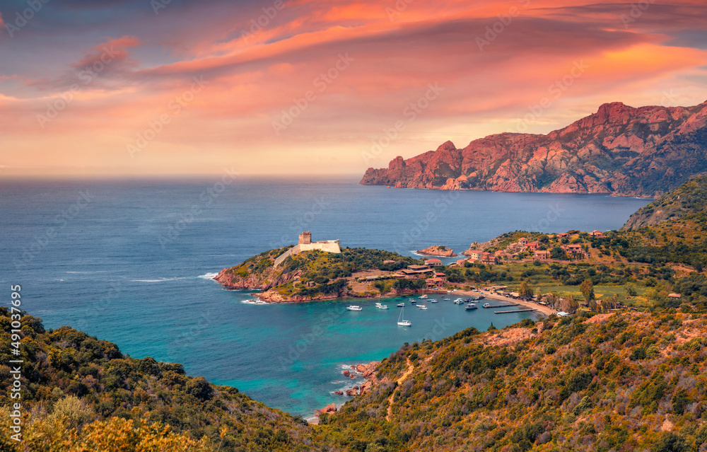 Colorful summer view of Port de Girolata - place, where you can't get by car. Impressive sunrise scene of Corsica island, France, Europe. Aerial Mediterranean seascape. Traveling concept background..