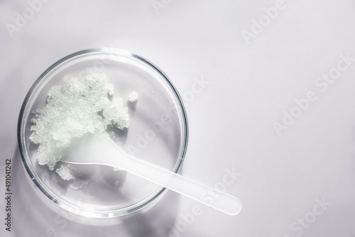 Cosmetic peeling scrub smudge textured on petri dish background
