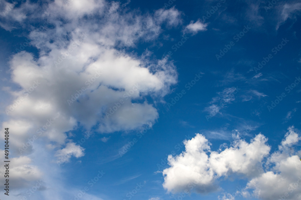 white clouds on sunny blue sky background