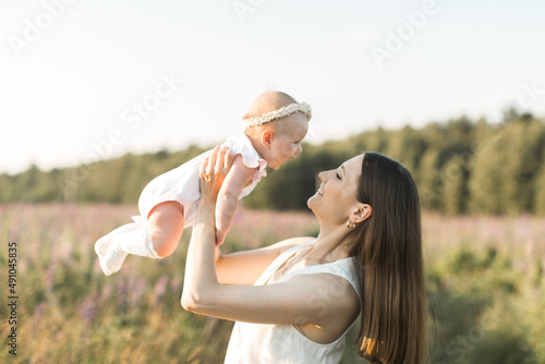 mother holds her child in her arms, nature, calm atmosphere