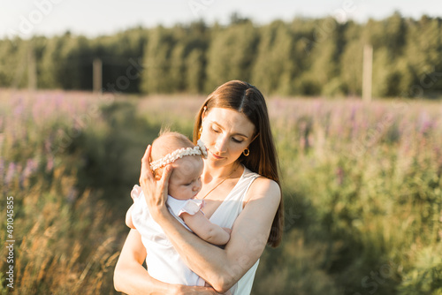 mother holds her child in her arms, nature, calm atmosphere