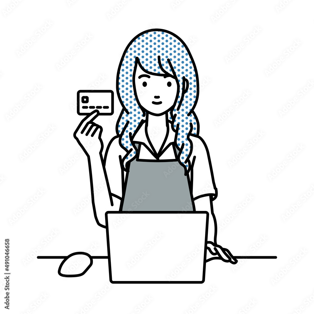 デスクで座ってPCを使いながらクレジットカードを手に持っているカフェ店員の女性