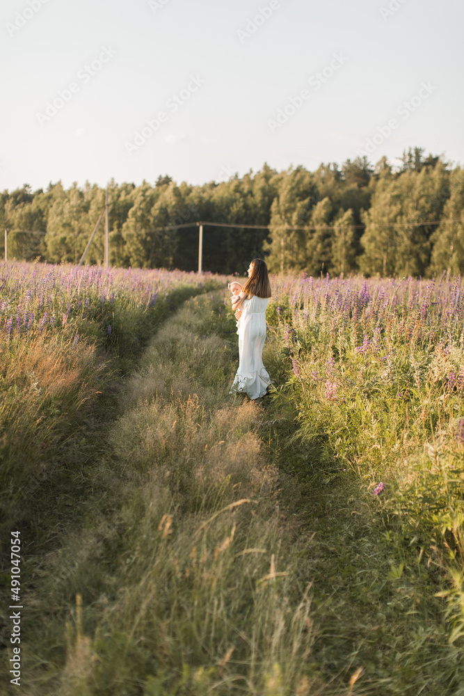 mother holds her child in her arms, nature, calm atmosphere