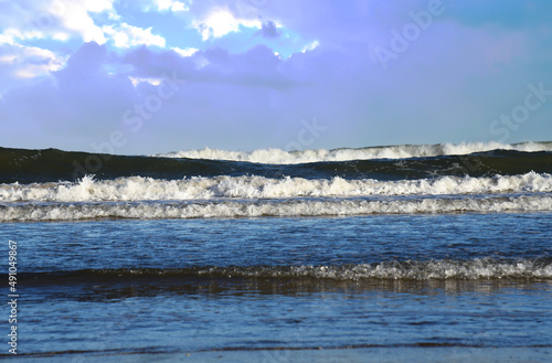 Waves at sea. Waves at sea during storm and wind. Wave from the sea goes on land to the beach. Splashing Waves in ocean, background, texture. Wave at Rising Storm.