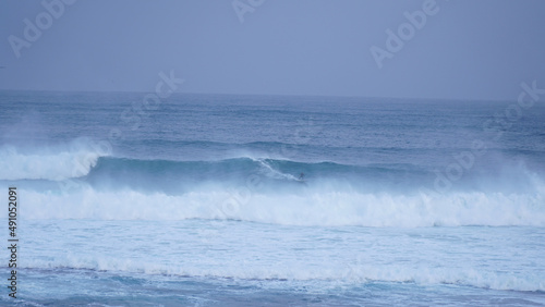 Surfer riding a wave at Surfers Point in Margaret River, Western Australia.