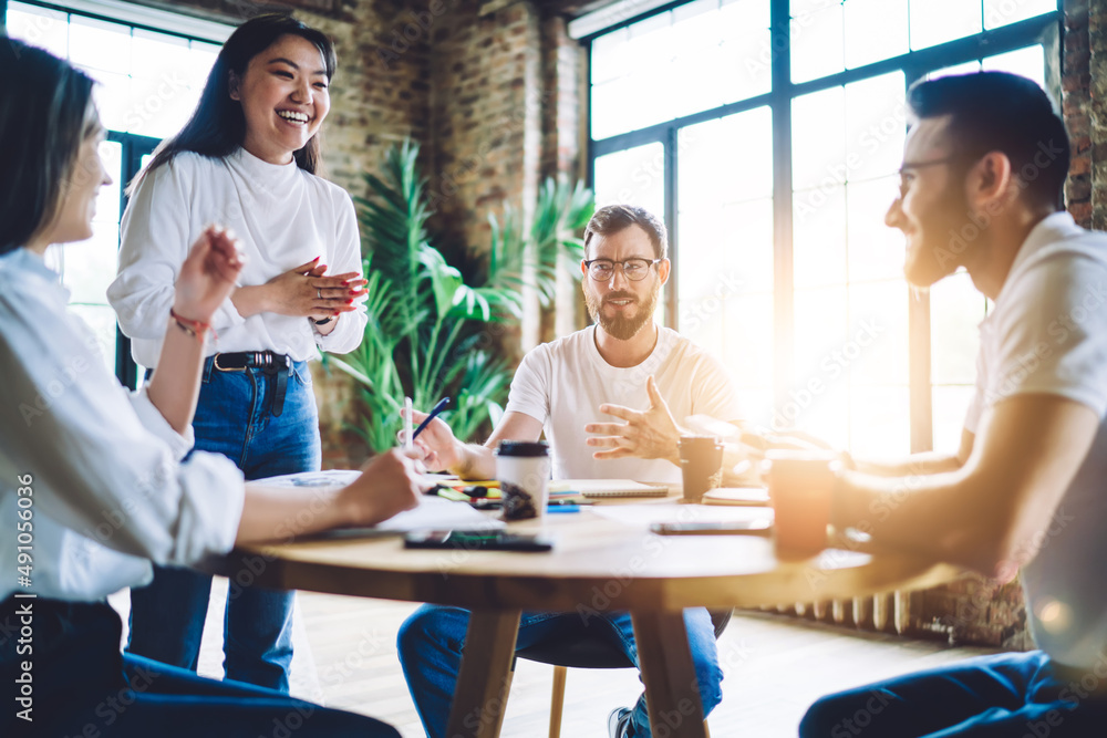 Laughing diverse colleagues discussing business ideas Laughing diverse colleagues discussing business ideas