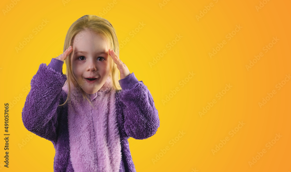 surprised little toddler girl in pajamas hands on her head yellow background surprised little toddler girl in pajamas hands on her head yellow background