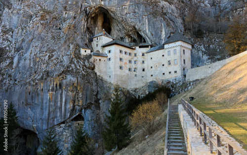 Late winter view of Predjama castle near Postojna, Slovenia, perched in the middle of a tall cliff and connected to a cave system