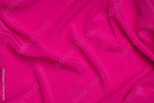Smooth elegant pink silk or satin texture can use as abstract background. Luxurious background design