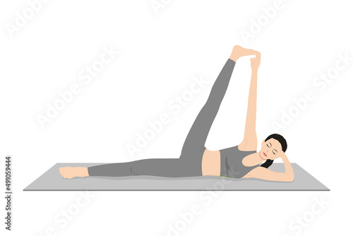 Side Reclining Leg Lift Pose, Vishnu Pose, Eternal One Pose. Beautiful girl practice Anantasana. Young attractive woman practicing yoga exercise. working out, black wearing sportswear, grey pants