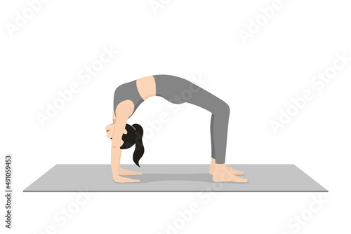Wheel pose, Chakrasana, Upward Bow Pose. Beautiful girl practice Urdhva Dhanurasana. Young attractive woman practicing yoga exercise. working out, black wearing sportswear, grey pants and top, indoor