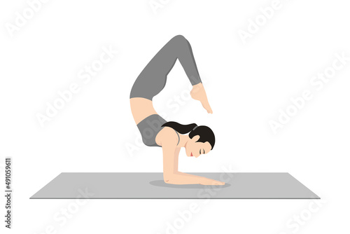 Scorpion Pose. Beautiful girl practice Vrschikasana. Young attractive woman practicing yoga exercise. working out, black wearing sportswear, grey pants and top, indoor full length, calmness and relax.