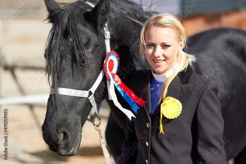 Hes more than just an animal to me. Shot of a beautiful young woman standing next to her horse.