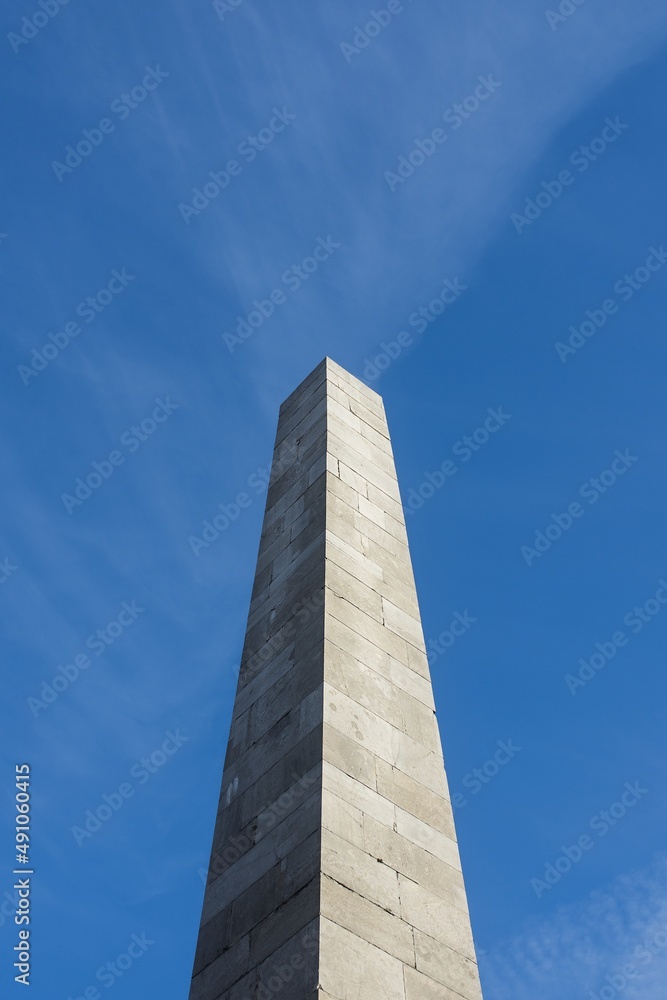 Photograph of the Monument to Victims. In background with beautiful blue sky and tiny clouds. Beautiful sunny weather.