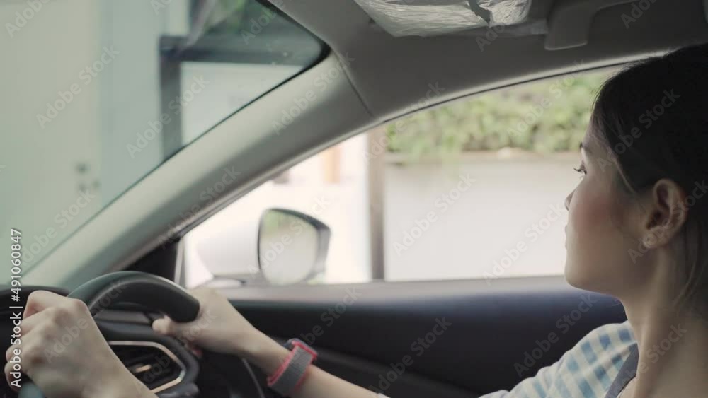 Beautiful Asian woman says to order food or drink through a screen outside the shop by driving through or drive-thru. Beautiful Asian woman says to order food or drink through a screen outside the shop by driving through or drive-thru.