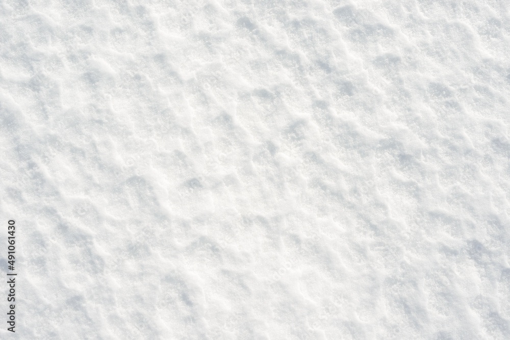 Obraz premium Fresh clean white snow background texture. Winter background with frozen snowflakes and snow mounds. Snow lumps. Seasonal landscape details. Cold weather.