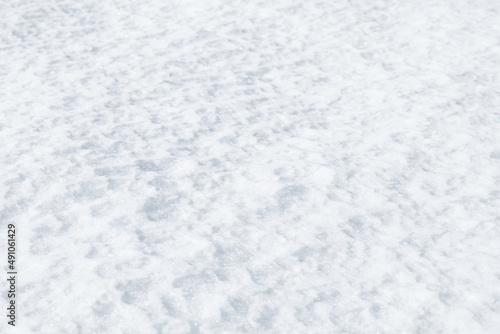 Fresh clean white snow background texture. Winter background with frozen snowflakes and snow mounds. Snow lumps. Seasonal landscape details. Cold weather.