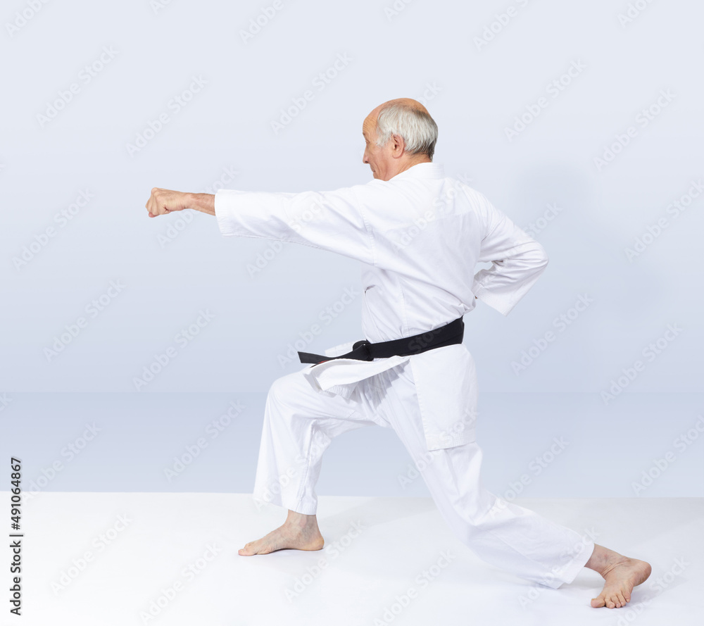 Blow arm adult karateka is beating in karategi Blow arm adult karateka is beating in karategi