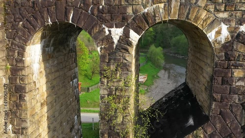 stone arched railway bridge over the Prut River in the Carpathians in the village of Vorokhta. One of the oldest and longest stone arched bridges (viaducts) in Europe: length 200 meters; photo