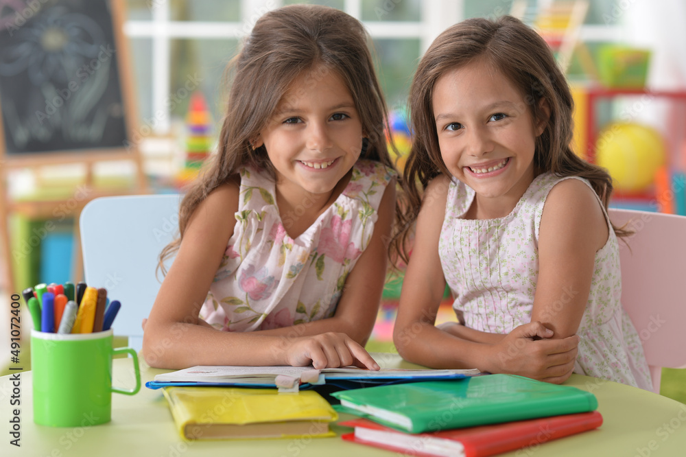 two beautiful little girls studying two beautiful little girls studying