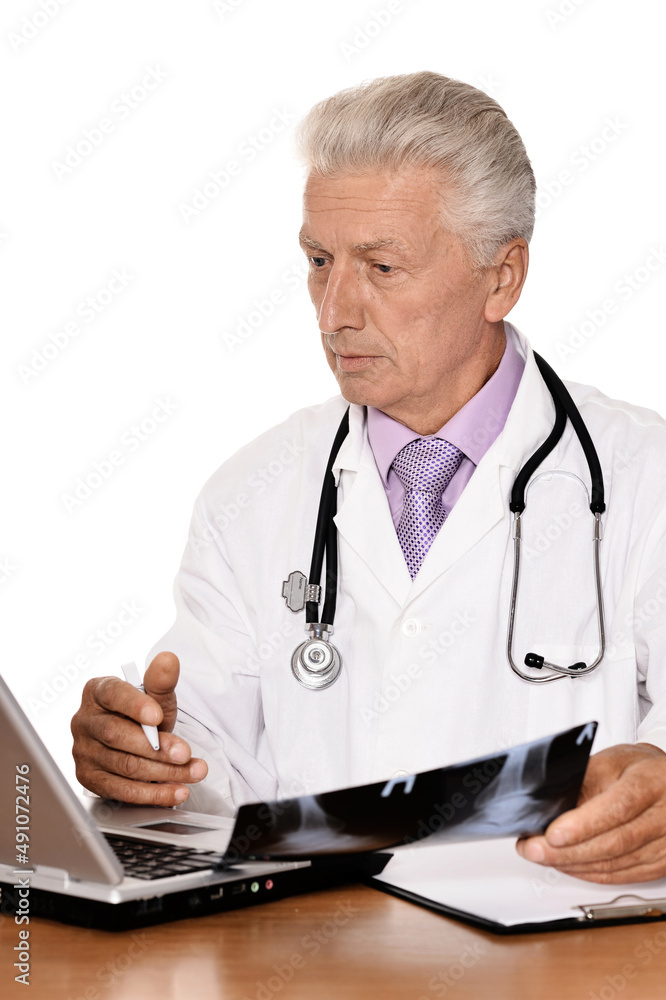 Elderly doctor with a laptop on white background Elderly doctor with a laptop on white background