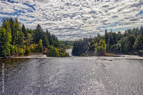 Bright sun shining on the water before the descent - Kakabeka Falls, Thunder Bay, ON, Canada photo