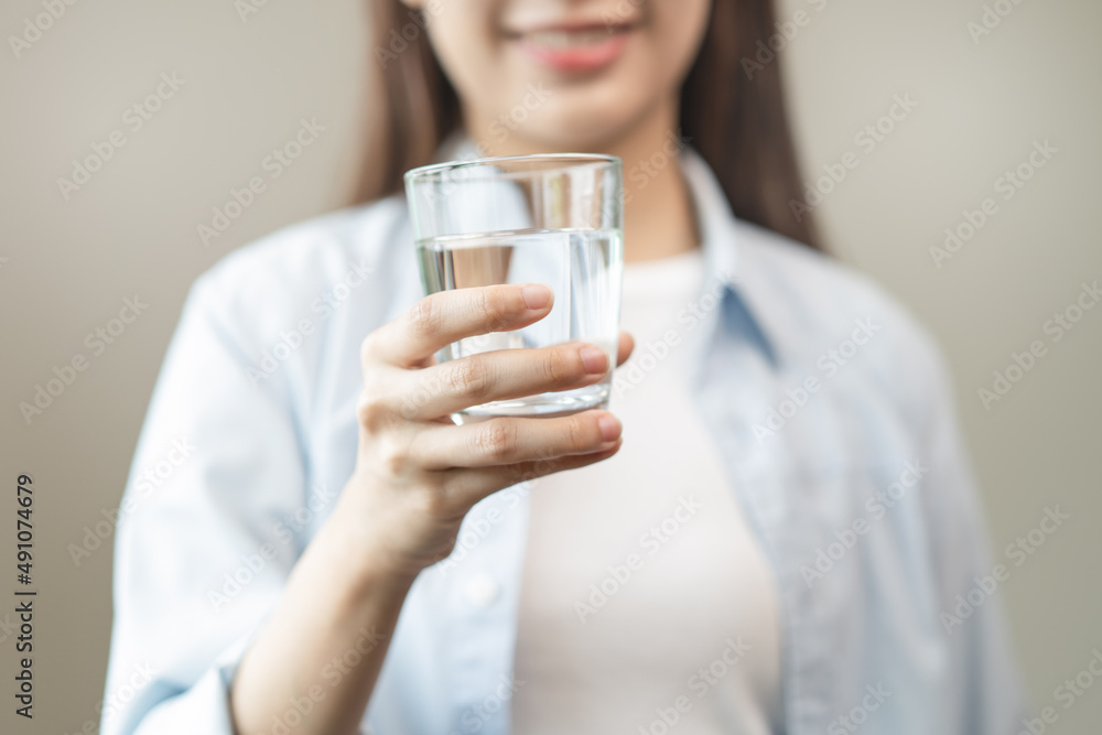 Clean freshwater concept. Woman drink mineral water in the morning for good health. Clean freshwater concept. Woman drink mineral water in the morning for good health.
