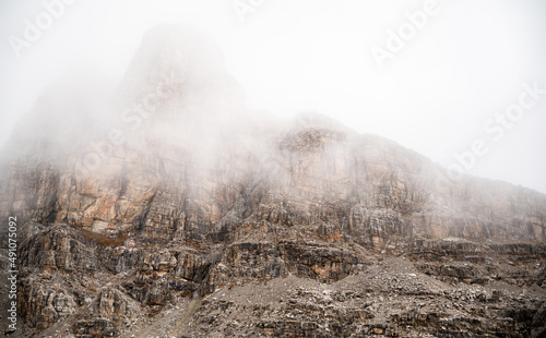 strong contrast clouds and cliffs space for text blurr background, high up n the mountains,  photo