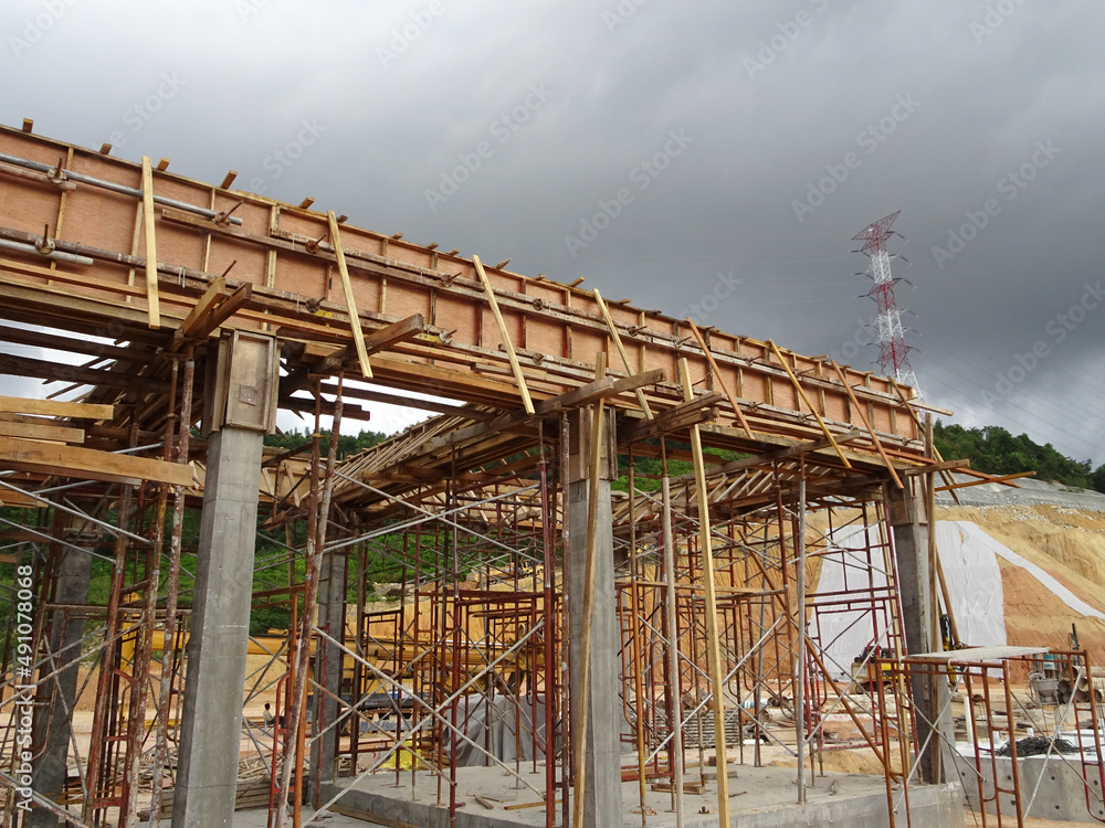 KUALA LUMPUR, MALAYSIA - JULY 7, 2021: Beam and column formwork installed at a construction site. Molds are made of wood and plywood. Be the basis of form to reinforced concrete.