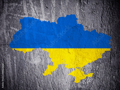 The outline of the state of Ukraine in the colors of the national flag painted on the damaged wall of a burnt house. Digital art. 