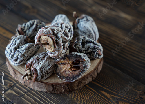 Dried persimmon on a wooden background. Healthy diet