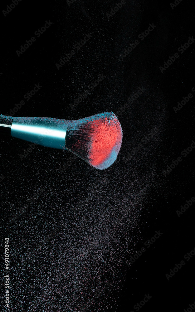 Make up brushes colliding and exploding with powder Make up brushes colliding and exploding with powder