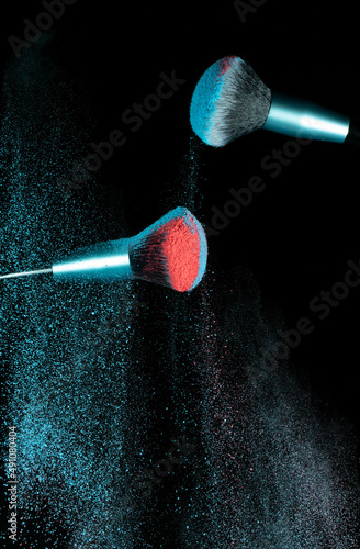 Make up brushes colliding and exploding with powder