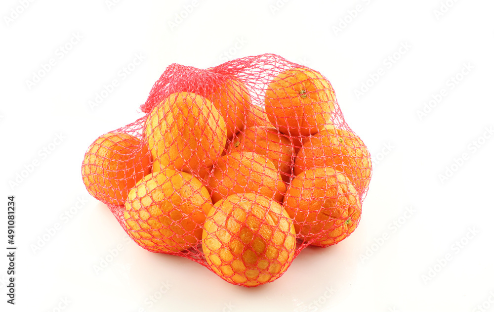Oranges in red net bag isolated on white background Oranges in red net bag isolated on white background