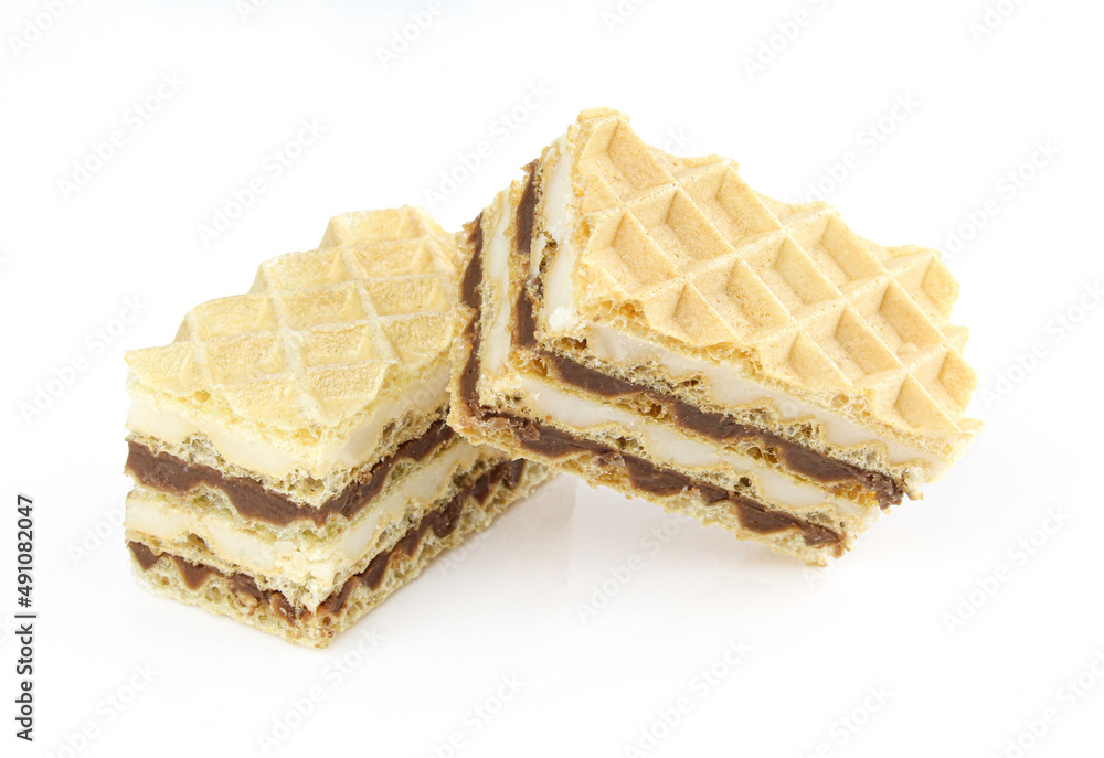 Four layers of vanilla and chocolate cream in 2 pieces of homemade oblate dessert Four layers of vanilla and chocolate cream in 2 pieces of homemade oblate dessert