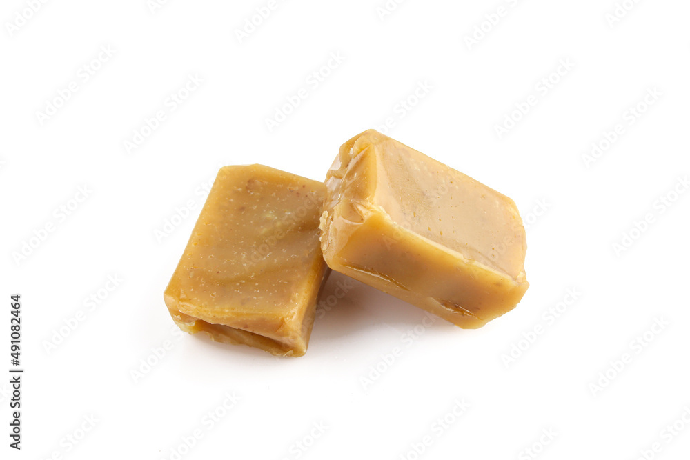Two hard caramel candies isolated on white background Two hard caramel candies isolated on white background