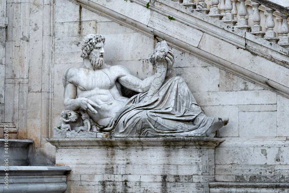 Rome, Italy - 20.02.2022: Close up of Tiber statue by Michelangelo. Part of exterior of Senatorial palace (Palazzo Senatorio) in Campidoglio square 