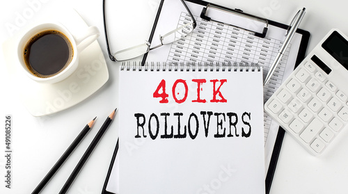 401K ROLLOVERS text on the paper with calculator, notepad, coffee ,pen with graph photo