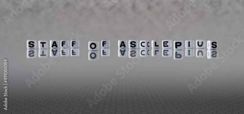 staff of asclepius word or concept represented by black and white letter cubes on a grey horizon background stretching to infinity