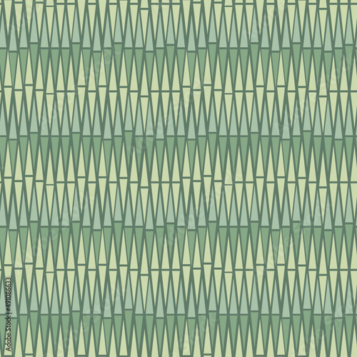 Seamless repeat pattern. Tiki inspired bamboo like background in muted, green colors.