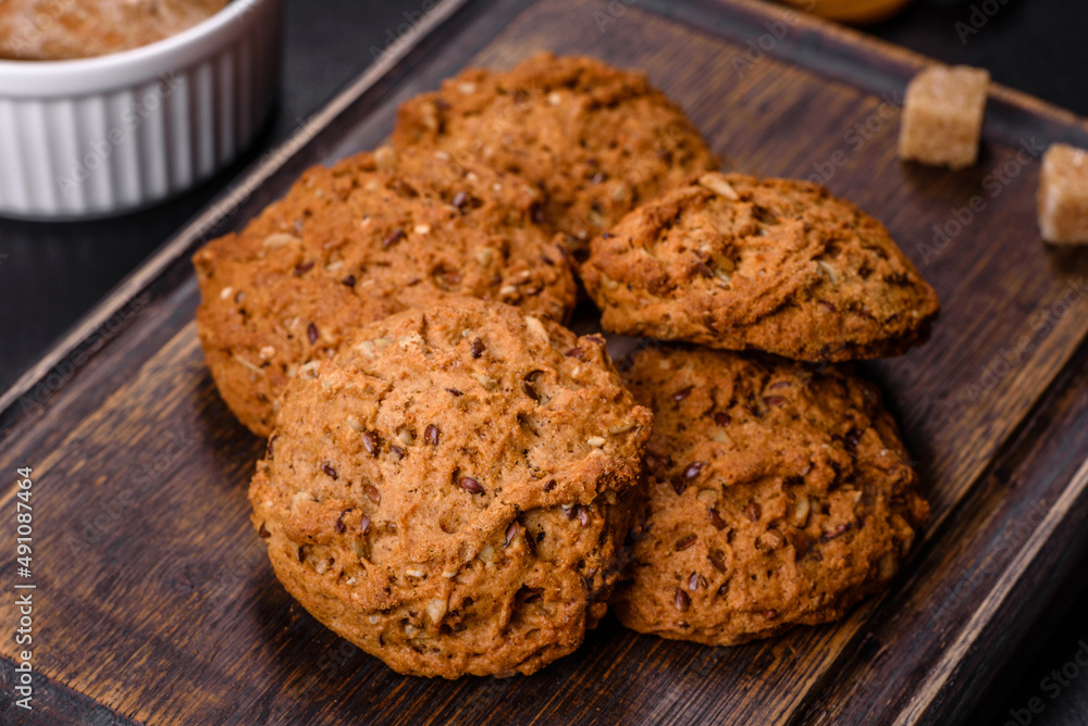 Tasty fresh oat cookies on a dark concrete background Tasty fresh oat cookies on a dark concrete background