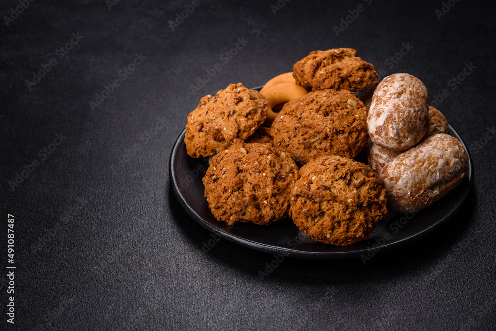 Tasty fresh oat cookies on a dark concrete background Tasty fresh oat cookies on a dark concrete background