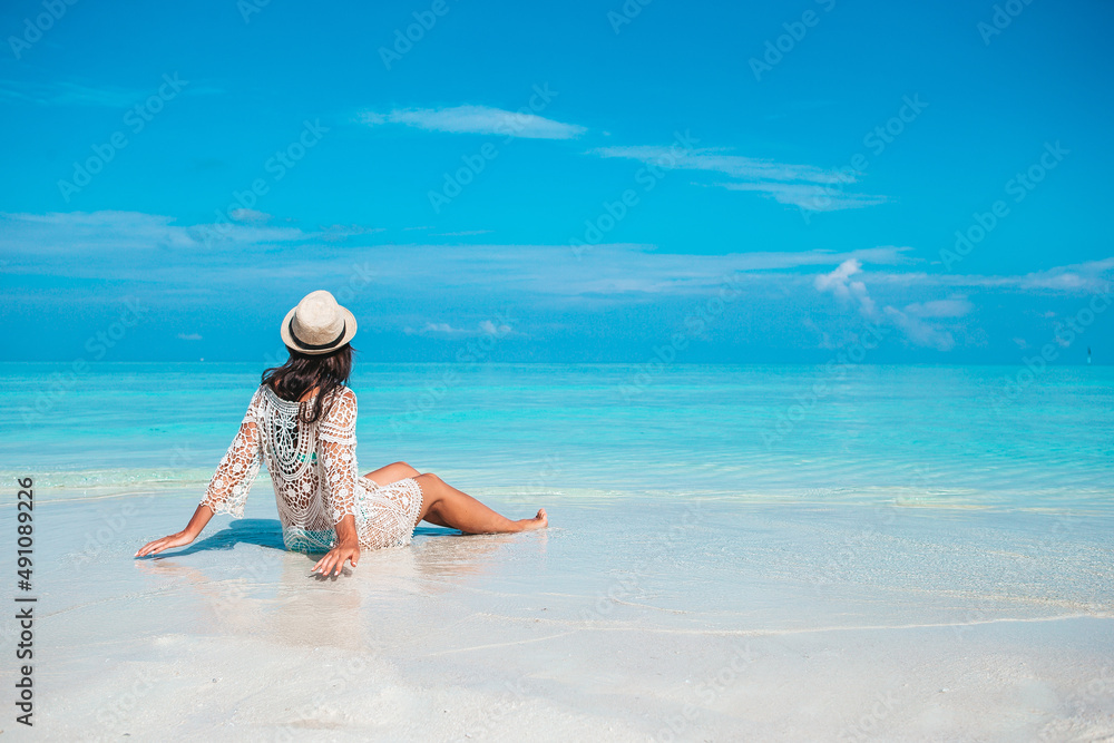Woman laying on the beach enjoying summer holidays looking at the sea Woman laying on the beach enjoying summer holidays looking at the sea