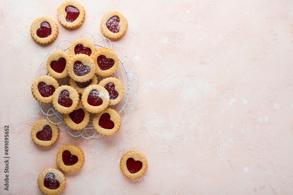 Traditional Linzer cookie with strawberry jam and powder sugar on pink beautiful background. Top view. Traditional homemade Austrian sweet dessert food on Valentines Day. Holiday snack concept. Traditional Linzer cookie with strawberry jam and powder sugar on pink beautiful background. Top view. Traditional homemade Austrian sweet dessert food on Valentines Day. Holiday snack concept.