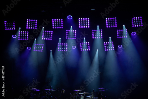 Dimmed stage overhead lights to illuminate musical concerts.