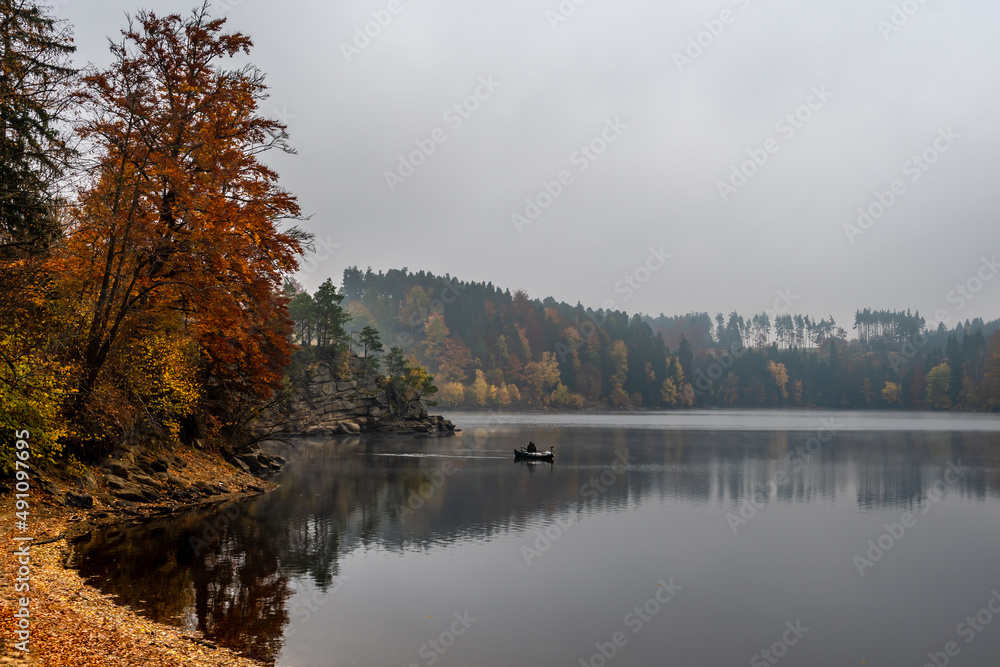 Foggy Landscape With Fishermans Boat On Calm Lake And Autumnal Forest At Lake Ottenstein In Austria