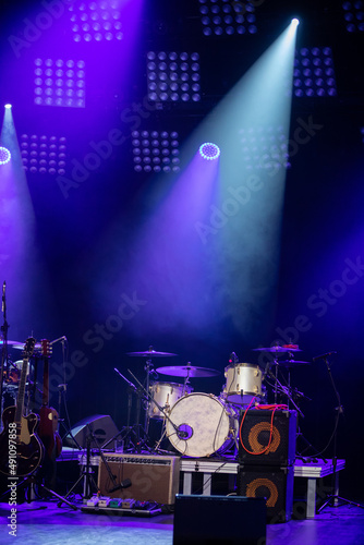 Set up music equipment for a rock concert with bright lighting.