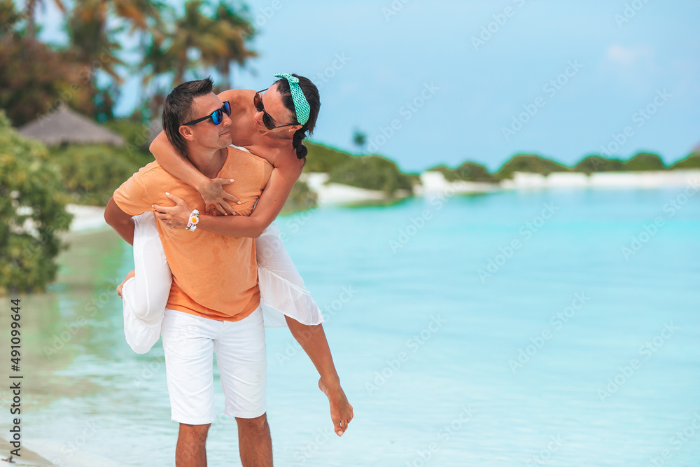 Young Family on white beach during summer vacation. Young Family on white beach during summer vacation.