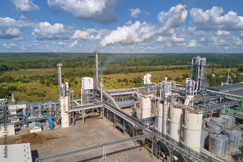Aerial view of oil and gas refining petrochemical factory with high refinery plant manufacture structure. Global production and manufacturing concept