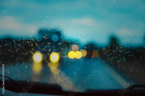 Blurry background with roads and trucks, the concept of cargo transportation and strenuous traffic